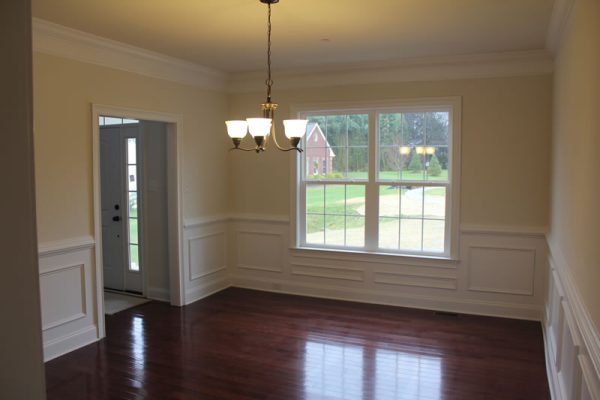A formal dining room with special millwork fit for a king & queen