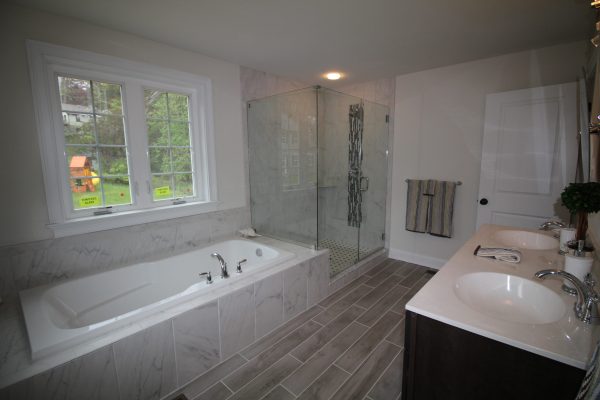 Comfortable bath featuring separate shower & jetted tub
