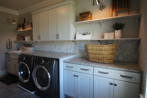 Laundry room featuring custom cabinetry & granite