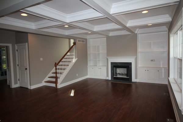 Family room features coffered ceiling & custom built-in cabinetry-