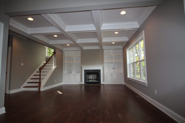Family room features coffered ceiling & custom built-in cabinetry