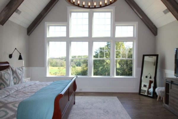 Owner's suite featuring exposed beams and cathedral ceiling